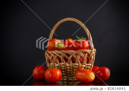 fresh ripe red tomatoes in basket isolated on black 82614041