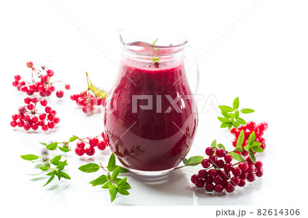freshly squeezed thick natural juice with pulp from ripe red viburnum in a decanter 82614306