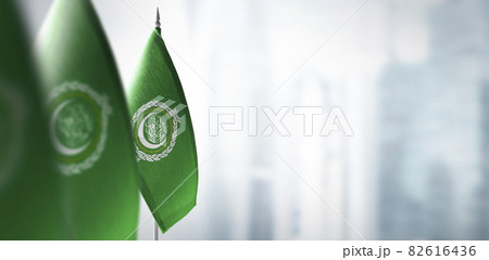 Small flags of Arab League on a blurry background of the city Small flags of Arab League on a blurry background of the city 82616436