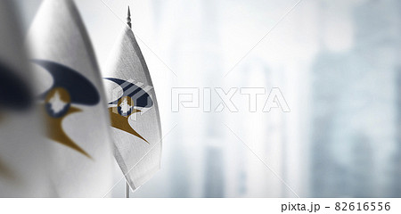 Small flags of Eurasian Economic Union on a blurry background of the city 82616556