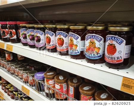 PENANG, MALAYSIA -MARCH 5, 2021: Selected focused on a variety of fruit jams displayed inside the supermarket. Sorted by the brand to facilitate customers. Tag with the price tag.  82620925
