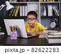Portrait of asian boy using laptop while studying at home, remote education concept 82622283