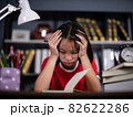 girl school student feeling headache or fatigue doing homework at home. Exhausted depressed sick teenager studying alone worried about difficult education problems concept. 82622286