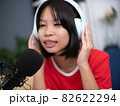 Little Asian girl singing a song in home recording studio. 82622294