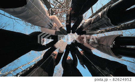 Group of young people having a rest outdoor in winter. 82624952