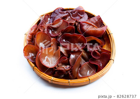 Black fungus mushroom in bamboo basket on white. 82628737