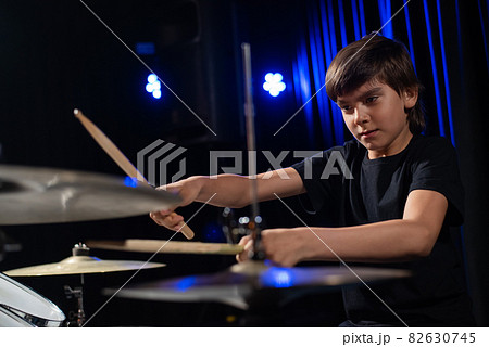 A boy plays drums in a recording studio 82630745