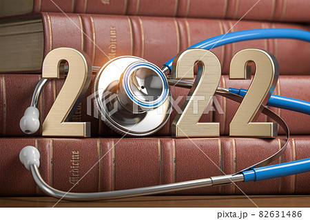 2022 Happy New Year for health care medicine and pharmacy industry. Number 2022 with stethoscope on vintage books of medicine. 82631486