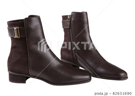 stylish brown ankle boots made of leather and suede, with a buckle, on a white background stylish brown ankle boots made of leather and suede, with a buckle, on a white background 82631690