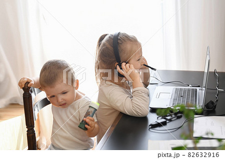 Little children play with computer of parents 82632916