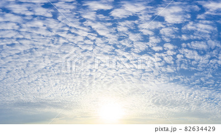 The brightness sun and fluffy white clouds full on blue sky, nature phenomenon picture. The brightness sun and fluffy white clouds full on blue sky, nature phenomenon picture. 82634429