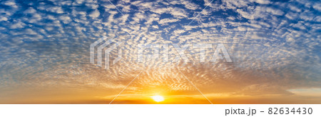 The bright sun and fluffy clouds full on blue sky, panorama nature picture. 82634430