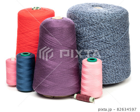Cones and spools of color threads on white background 82634597