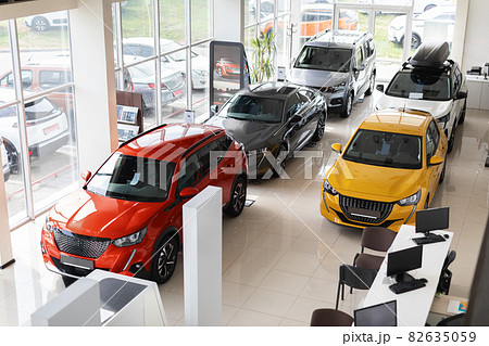 Beautiful modern cars at luxury dealership salon, view above Beautiful modern cars at luxury dealership salon, view above 82635059