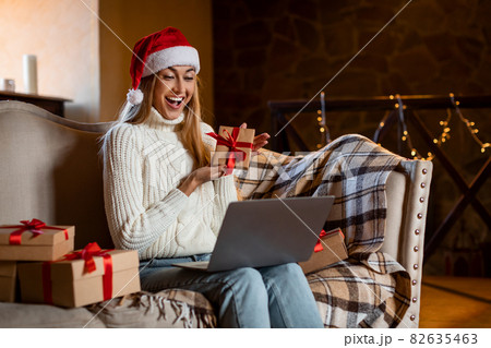Happy Woman Holding Present Box Using Laptop For Video Call 82635463