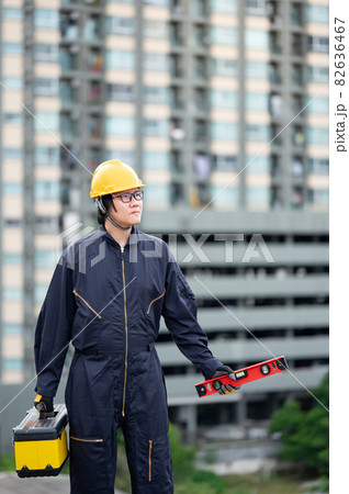 Worker man carrying work tool at construction site 82636467