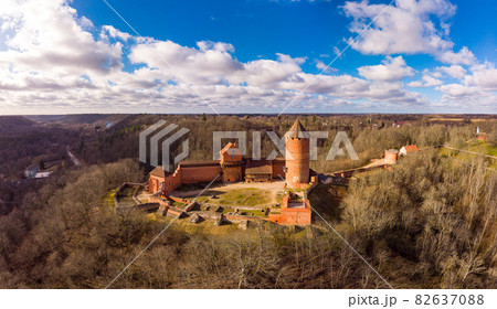 Aerial view over River Gauja valley, with Turaida Castle in the middle of it during cloudy summer day, Sigulda, Latvia. Aerial view over River Gauja valley, with Turaida Castle in the middle of it during cloudy summer day, Sigulda, Latvia. 82637088