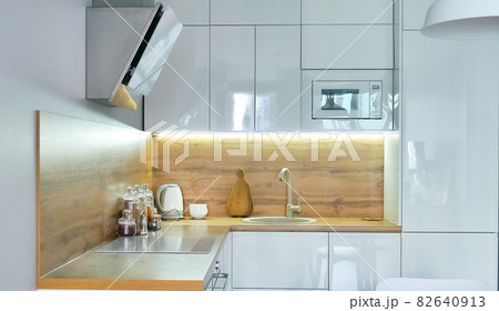 Modern kitchen interior with wooden and white elements, domestic life, home showcase interior concept Modern kitchen interior with wooden and white elements, domestic life, home showcase interior concept 82640913
