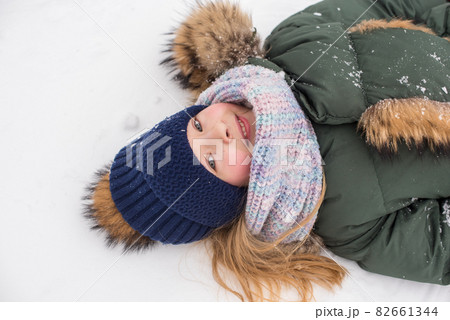 Happy child girl plaing with snow on a snowy winter walk 82661344