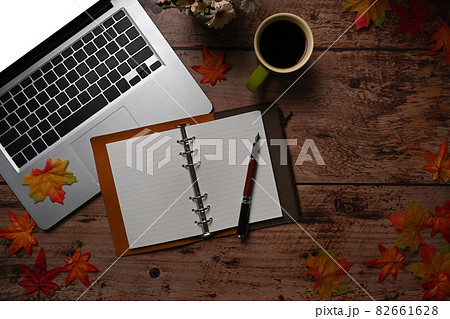 Notebook, Computer laptop, coffee cup and autumn maple leaves on wooden background. Notebook, Computer laptop, coffee cup and autumn maple leaves on wooden background. 82661628