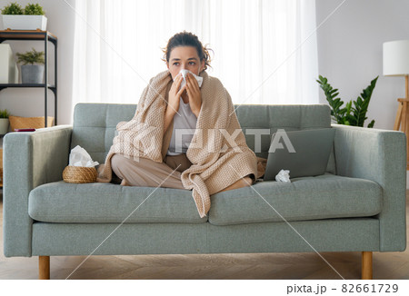 girl is holding paper tissue and blowing nose girl is holding paper tissue and blowing nose 82661729