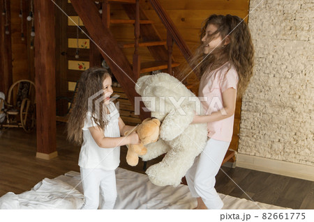 A beautiful girls with Teddy bear, a child with toy. The concept of childhood, morning pastime A beautiful girls with Teddy bear, a child with toy. The concept of childhood, morning pastime 82661775