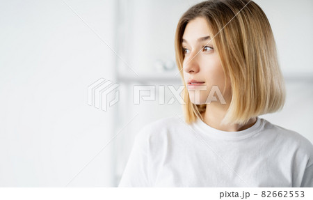 Beauty portrait. Fresh face. Female wellness. Pretty pure woman with flawless smooth skin isolated on defocused light copy space background. Beauty portrait. Fresh face. Female wellness. Pretty pure woman with flawless smooth skin isolated on defocused light copy space background. 82662553