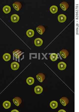 Pattern of kiwi. Top view of the sliced kiwi on black background. Minimal flat lay concept. Pattern of kiwi. Top view of the sliced kiwi on black background. Minimal flat lay concept. 82662701