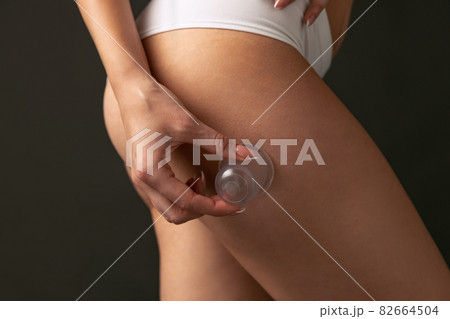 Beautiful female hips and legs isolated on dark studio background. Natural beauty, spa, anti-cellulite treatments concept. 82664504