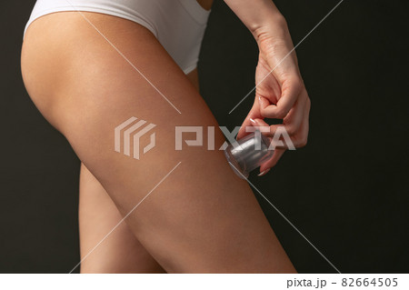 Beautiful female hips and legs isolated on dark studio background. Natural beauty, spa, anti-cellulite treatments concept. 82664505