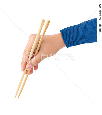 Hand with chopsticks Hand with chopsticks 82666189