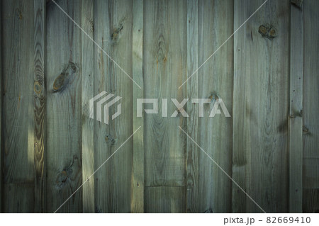 Wooden logs of an old house. Close-up. Weathered green wood texture. Background. Horizontal vertical photo. Wooden logs of an old house. Close-up. Weathered green wood texture. Background. Horizontal vertical photo. 82669410