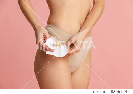 Beautiful body of young caucasian woman isolated on pink color studio background. Natural beauty concept 82669440