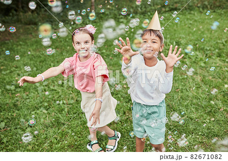 Girls Chasing Bubbles in Park Girls Chasing Bubbles in Park 82671082