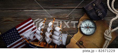 Columbus Day. Vintage discovery equipment with copy space on dark wooden background. Columbus Day. Vintage discovery equipment with copy space on dark wooden background. 82671229