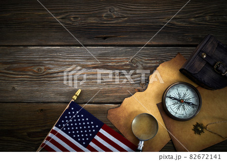 Columbus Day. Vintage discovery equipment with copy space on dark wooden background. Columbus Day. Vintage discovery equipment with copy space on dark wooden background. 82672141