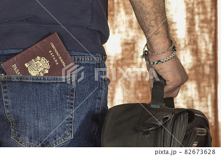 man with suitcase and passport in pocket man with suitcase and passport in pocket 82673628