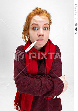 Cropped portrait of young Caucasian girl measuring temperature with electronic thermometer isolated over white background Cropped portrait of young Caucasian girl measuring temperature with electronic thermometer isolated over white background 82676693