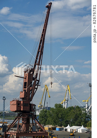 Large red harbor crane on the background of an industrial city. 82676781