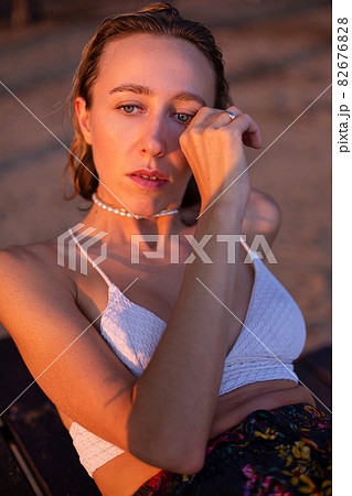Girl with blonde hair with sand on background Girl with blonde hair with sand on background 82676828