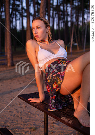 Girl with blonde hair with trees behind Girl with blonde hair with trees behind 82676836