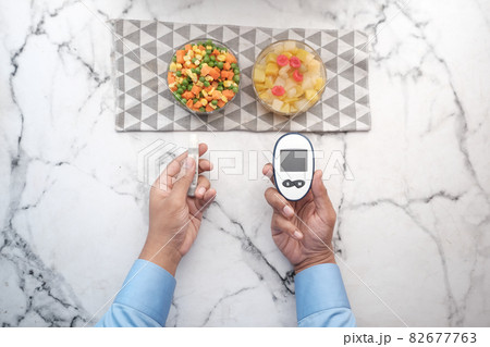 man's hand measuring blood sugar level  82677763