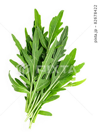Arugula leaves isolated on white background. Closeup fresh wild rocket leaves on white background top view. 82678422