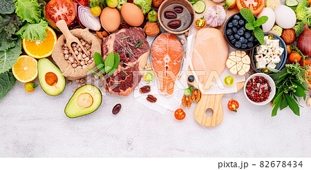 Ketogenic low carbs diet concept. Ingredients for healthy foods selection set up on white concrete background. Ketogenic low carbs diet concept. Ingredients for healthy foods selection set up on white concrete background. 82678434