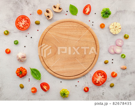 The ingredients for homemade pizza set up on white concrete background. The ingredients for homemade pizza set up on white concrete background. 82678435