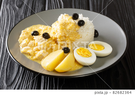 chicken in a creamy sauce with parmesan, pepper and onion, served with rice and boiled eggs close-up in a plate. horizontal 82682364