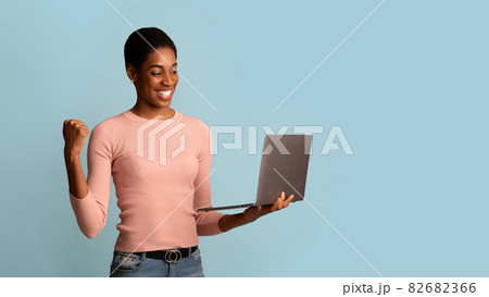 Joyful Black Woman Celebrating Success With Laptop, Raising Clenched Fist With Excitement 82682366
