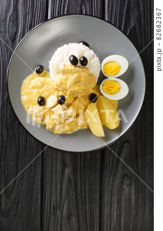 Peruvian Spicy Creamed Chicken with rice in the plate. Vertical top view 82682367