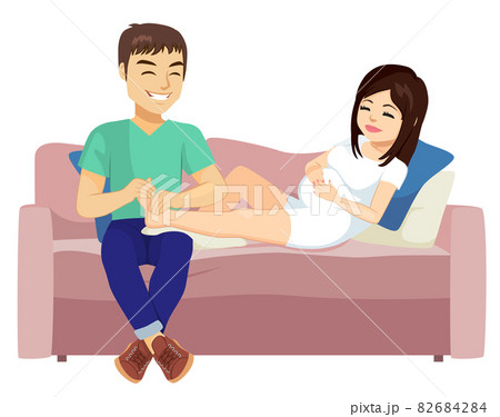 Husband doing foot massage to his pregnant woman wife 82684284