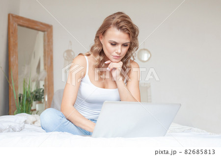 Beautiful young woman with laptop at home Beautiful young woman with laptop at home 82685813